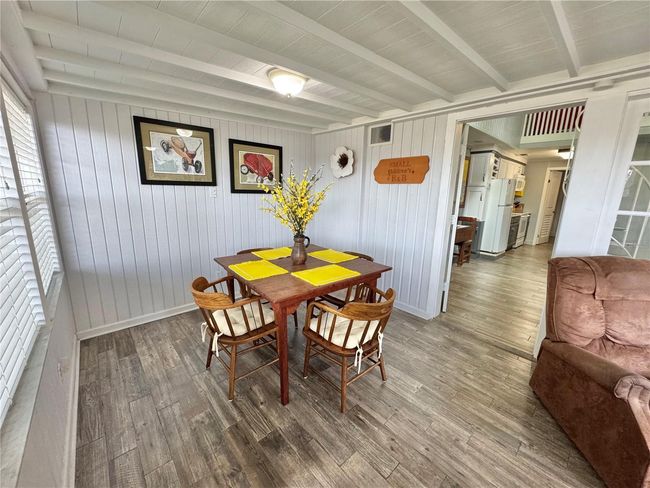 Front Florida room with a pull out couch for sleeping and chairs for sitting area and table/chairs eating area. Can be closed off for privacy. | Image 21