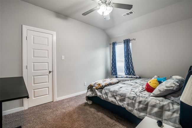 Bedroom with carpet flooring, vaulted ceiling, and a ceiling fan | Image 23