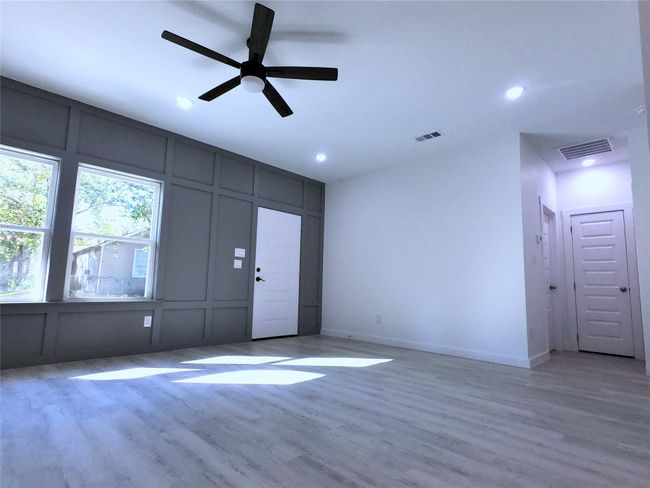 Unfurnished living room featuring visible vents, recessed lighting, and a decorative wall | Image 18