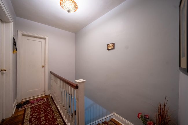 Hallway with an upstairs landing and wood finished floors | Image 17