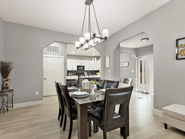 Dining room featuring light wood-style floors, arched walkways, and baseboards | Image 16