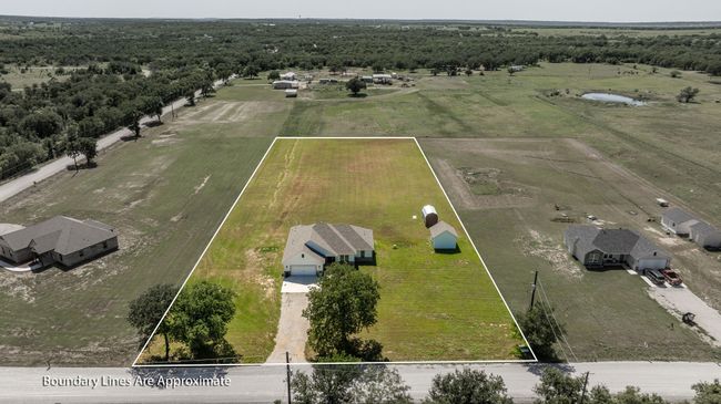 Aerial view of sparsely populated area featuring property boundaries highlighted and a heavily wooded area | Image 35