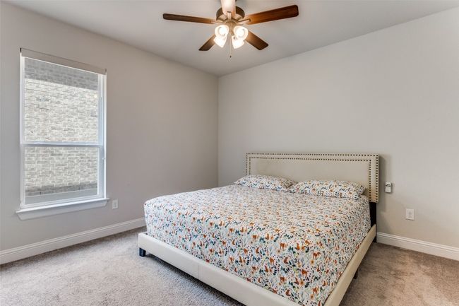 Carpeted bedroom with baseboards and a ceiling fan | Image 7