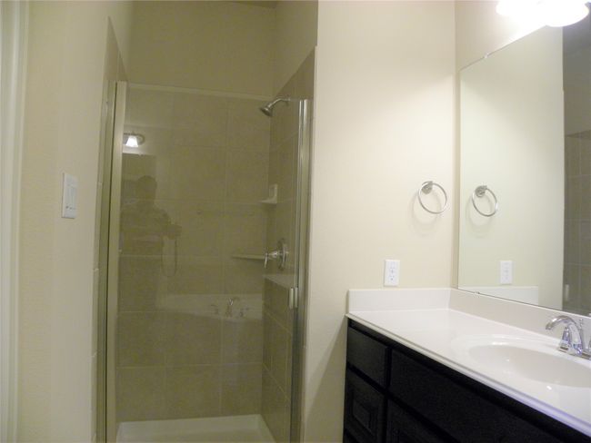 Bathroom featuring a shower stall and vanity | Image 24