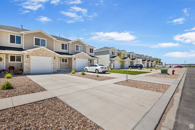View of yard with a residential view, driveway, and a garage | Image 5