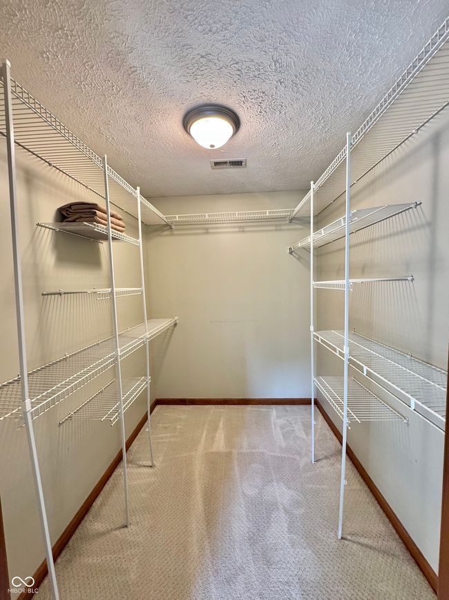 walk in closet featuring carpet flooring | Image 60