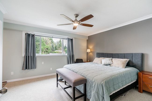 Carpeted bedroom featuring baseboards, ornamental molding, and a ceiling fan | Image 17