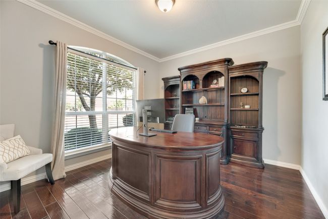 Office area with dark wood finished floors and crown molding | Image 11