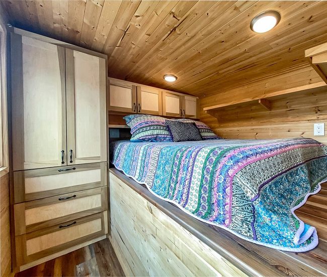 Bedroom with wooden ceiling, wood finished floors, and wooden walls | Image 34