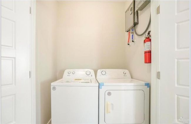 Clothes washing area featuring washer and clothes dryer | Image 11