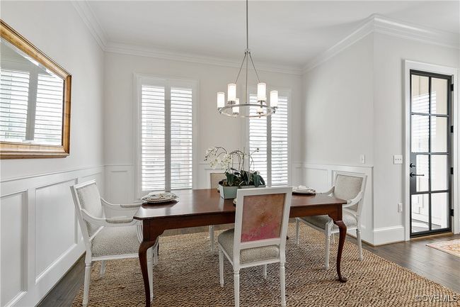 Dining space featuring ornamental molding, dark wood-style flooring, and a healthy amount of sunlight | Image 5