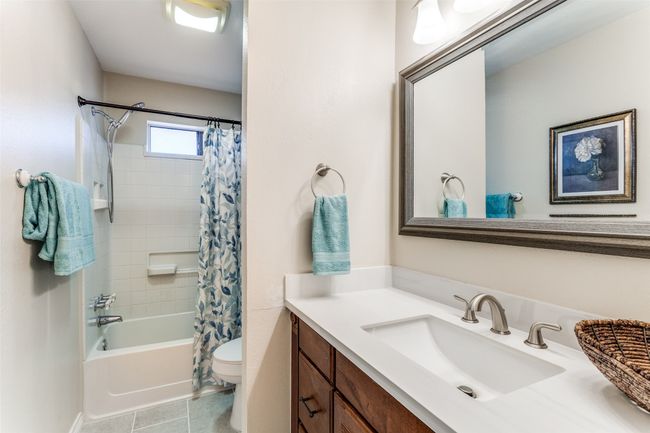 Full bathroom with vanity, shower / tub combo, and tile patterned flooring | Image 17