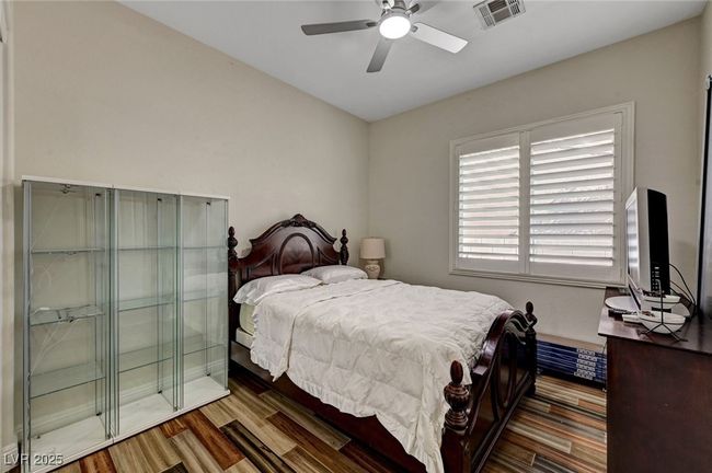 Bedroom with wood finished floors and ceiling fan | Image 44