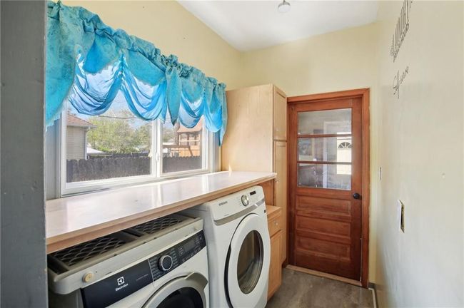 Clothes washing area with washer and dryer and laundry area | Image 14