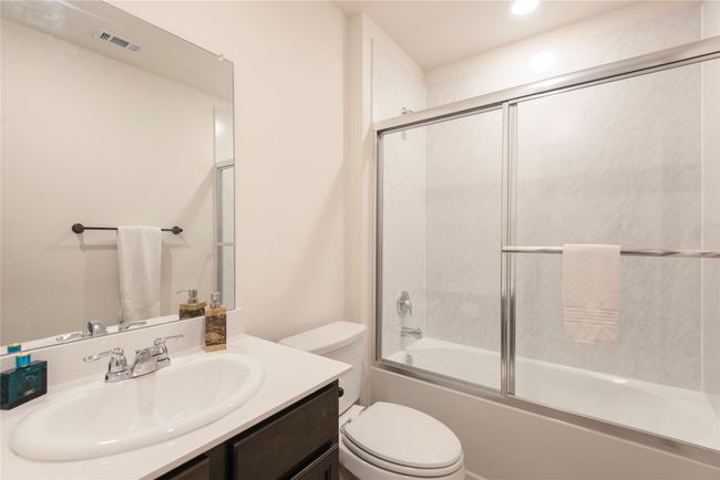 Full bath featuring vanity, shower / bath combination with glass door, and recessed lighting | Image 8