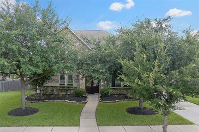 Mature trees and lush landscaping provide shade and great curb appeal! | Image 2