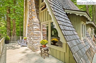 Beautiful stone chimney, wood shake roof and large deck. | Image 2