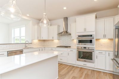 (Photo is of an inventory home, actual homes finishes will vary) Welcome to the Springfield! This spacious gourmet kitchen features a large center island, LVP floors, stainless appliances and more. Note: There will be no morning room. | Image 2