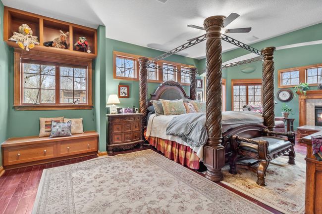 Primary bedroom suite. High ceilings. Mahogany hardwood floors. Showing open to sitting area with fireplace and door to full length deck. Ceiling speakers connected to whole house audio. | Image 20
