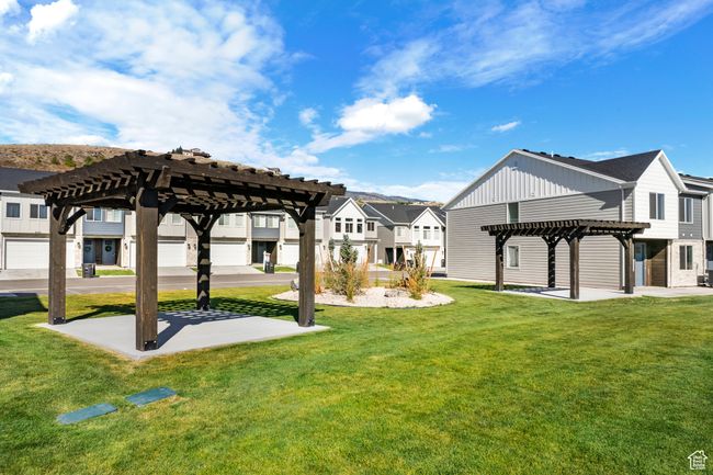 View of home's community featuring a yard, a residential view, and a pergola | Image 32