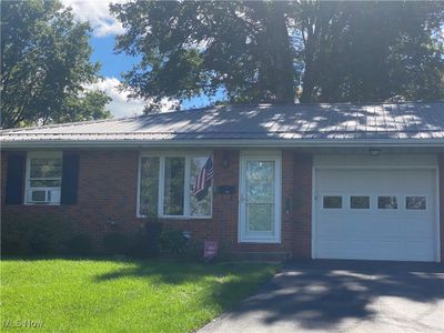 View of front facade featuring a garage and a front lawn | Image 2