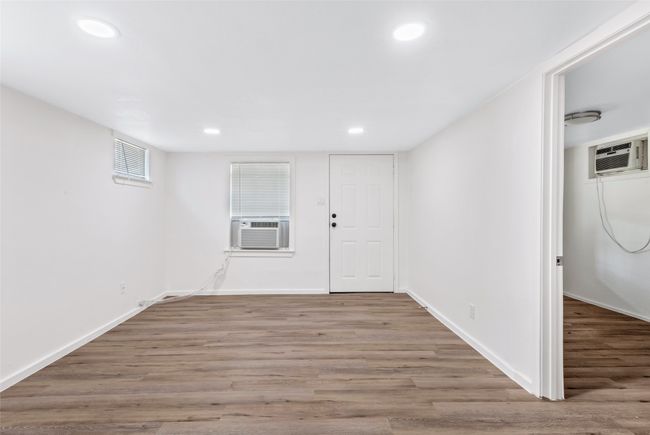Basement featuring recessed lighting, wood finished floors, cooling unit, and an AC wall unit | Image 31