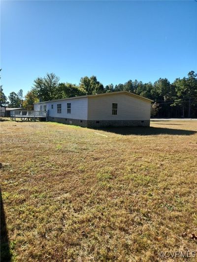 View of property exterior with a lawn | Image 3