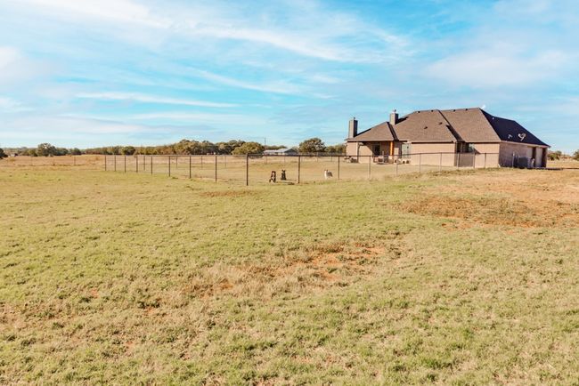 View of yard with a rural view and fence | Image 34