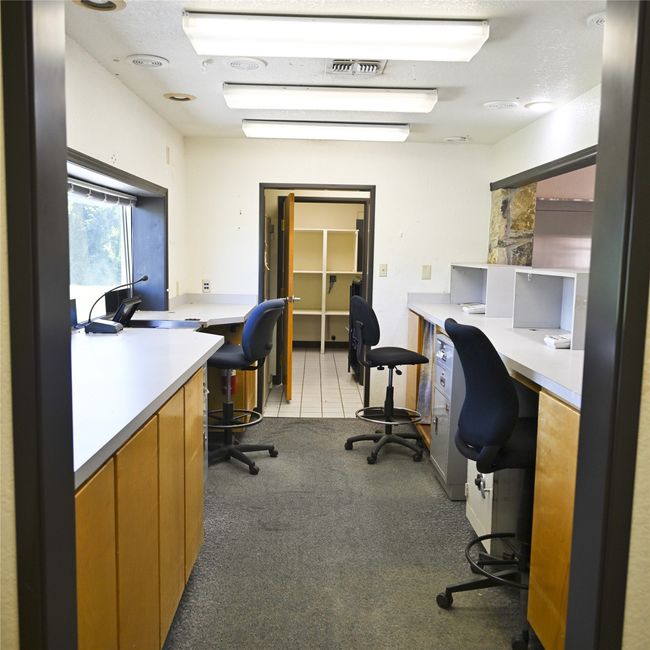 Office space featuring built in desk and light carpet | Image 13
