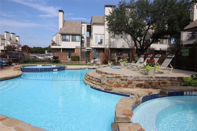 View of pool with a patio, fence, and a pool with connected hot tub | Image 23