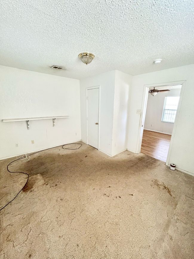Spare room featuring carpet floors and a textured ceiling | Image 13