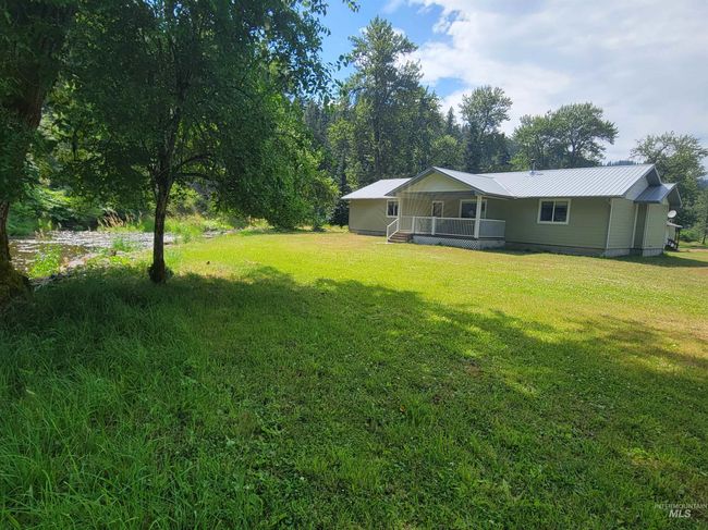 View of grassy yard featuring covered porch | Image 5