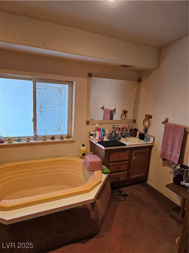 Bathroom featuring vanity and a bath | Image 15