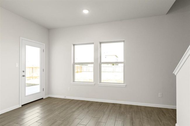 Spare room with plenty of natural light, baseboards, and wood finished floors | Image 9
