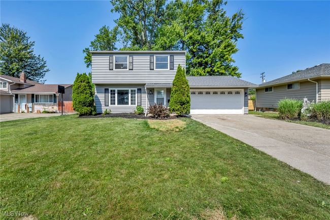 View of front of property featuring an attached garage, a front yard, and driveway | Image 4