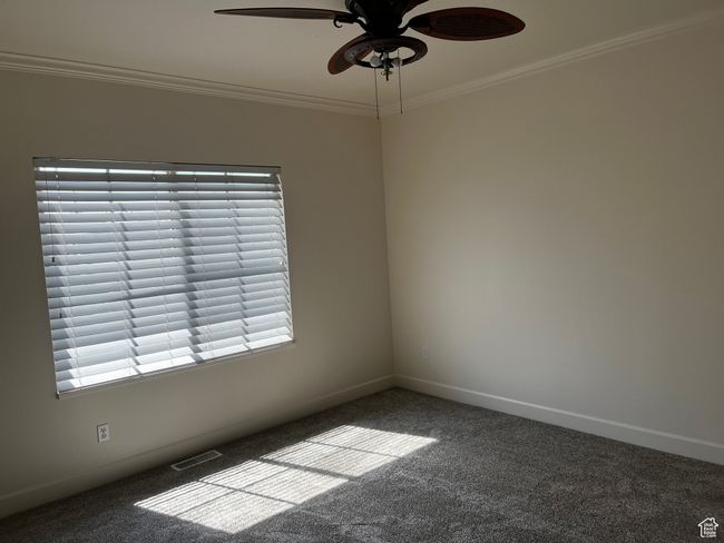 Carpeted spare room with ornamental molding, a ceiling fan, and healthy amount of natural light | Image 18