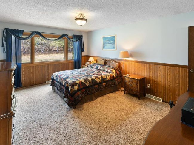 Primary Bedroom with 1/2 bath facing the backyard. Could possibly enlarge 1/2 bath by using storage closet area next to it. | Image 16