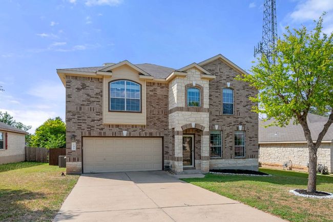 French country style house with concrete driveway, an attached garage, brick siding, and central AC | Image 35