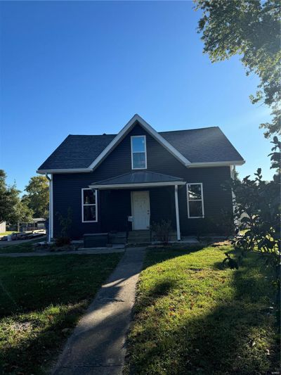 View of front of property featuring covered porch and a front lawn | Image 1