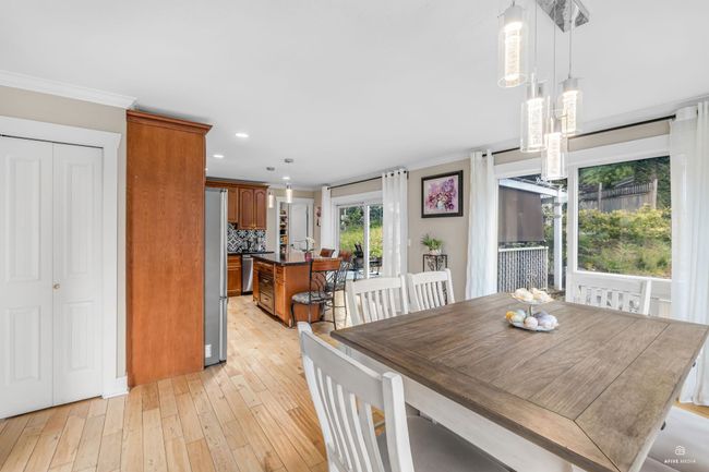 Dining area featuring light wood-style floors, crown molding, and recessed lighting | Image 13