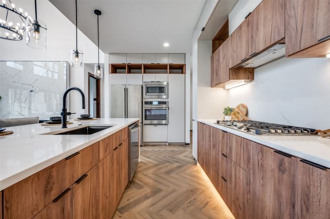 Kitchen with appliances with stainless steel finishes, modern cabinets, recessed lighting, brown cabinets, and decorative light fixtures | Image 11