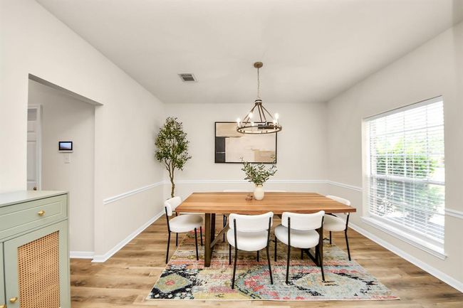 The formal dining room offers seamless access to the kitchen, making entertaining feel effortless. | Image 6
