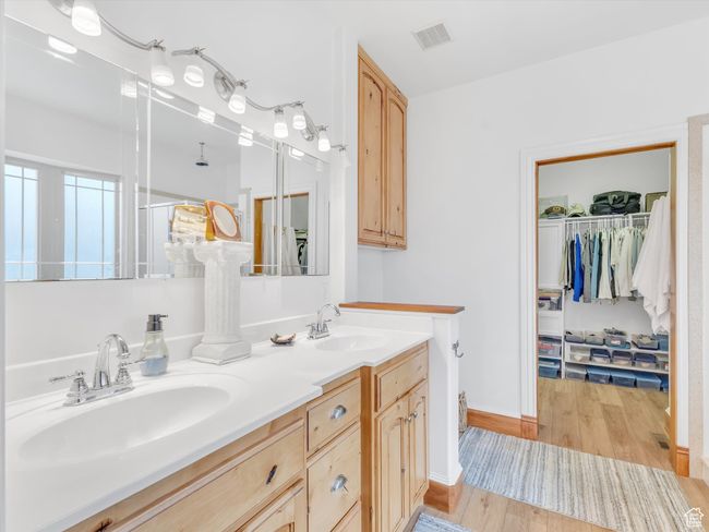 Full bathroom with wood finished floors, visible vents, a sink, and double vanity | Image 21