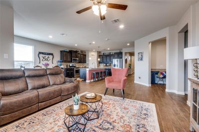 Living room featuring ceiling fan, sink, and light hardwood / wood-style floors | Image 2