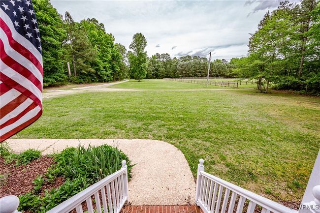 View of grassy yard featuring view of scattered trees | Image 8