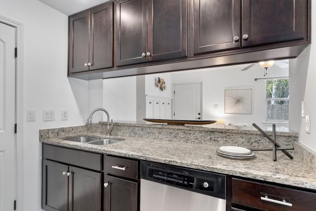 The large breakfast bar doubles as a dining space, ideal for enjoying meals and hosting guests. | Image 13