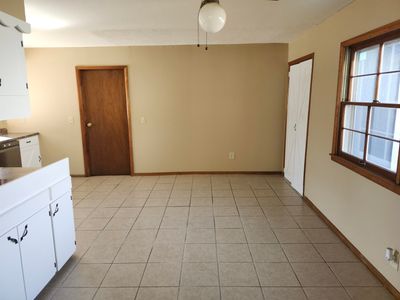 Unfurnished dining area with light tile patterned flooring and ceiling fan | Image 3