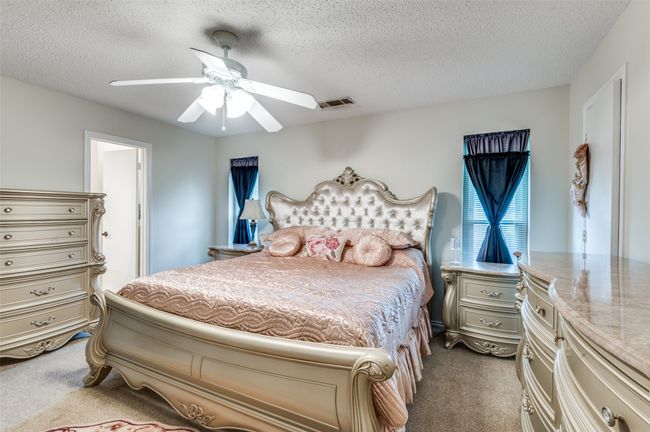 Bedroom with carpet, a textured ceiling, and ceiling fan | Image 10