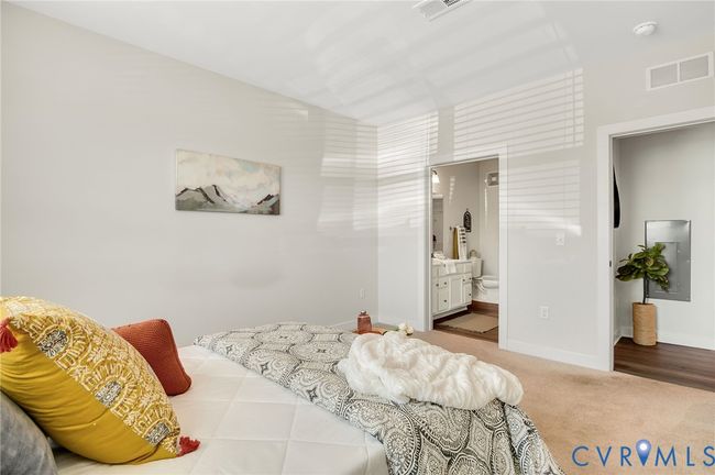 Carpeted bedroom with baseboards and ensuite bathroom | Image 13