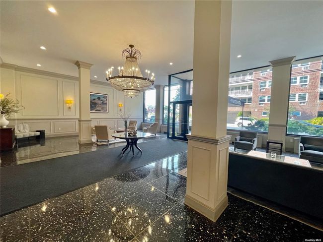 Community lobby with a decorative wall, a wainscoted wall, and recessed lighting | Image 25